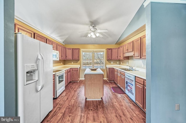 135 Bluewater Blvd S, Mineral, VA 23117 - kitchen featuring white appliances, a kitchen island, vaulted ceiling, wood finished floors, and light countertops