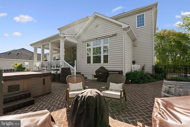  - view of patio / terrace with a hot tub and a ceiling fan
