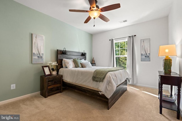  - bedroom featuring light carpet and a ceiling fan