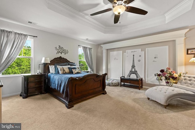  - bedroom featuring a raised ceiling, ornamental molding, light colored carpet, and ceiling fan