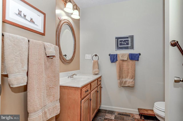 bathroom with vanity and toilet