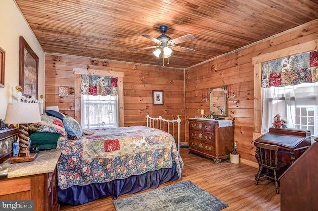 bedroom with hardwood / wood-style floors, wooden walls, and wood ceiling