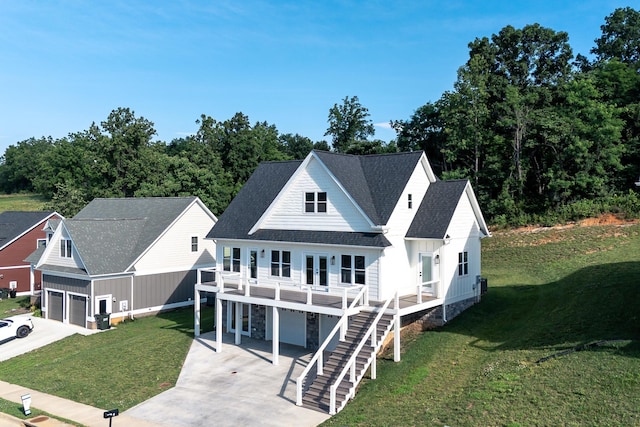 43 Mcilwee Ln, Staunton, VA 24401 - view of front of home with concrete driveway, board and batten siding, an attached garage, a front yard, and stairs