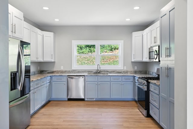 43 Mcilwee Ln, Staunton, VA 24401 - kitchen featuring stainless steel appliances, light stone countertops, recessed lighting, light wood finished floors, and white cabinetry