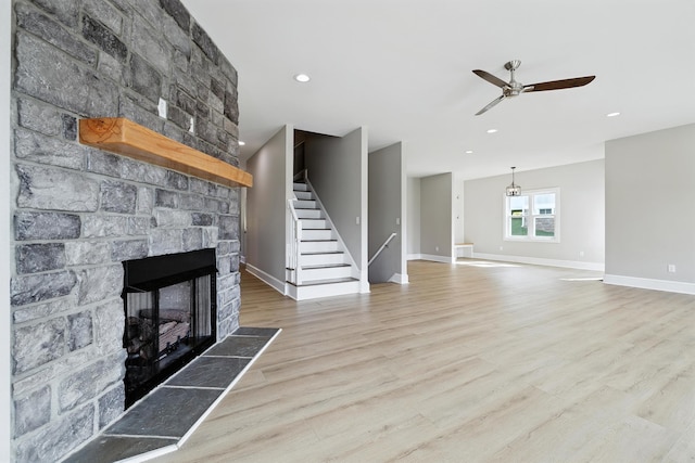 43 Mcilwee Ln, Staunton, VA 24401 - unfurnished living room featuring a fireplace, a ceiling fan, wood finished floors, stairs, and recessed lighting