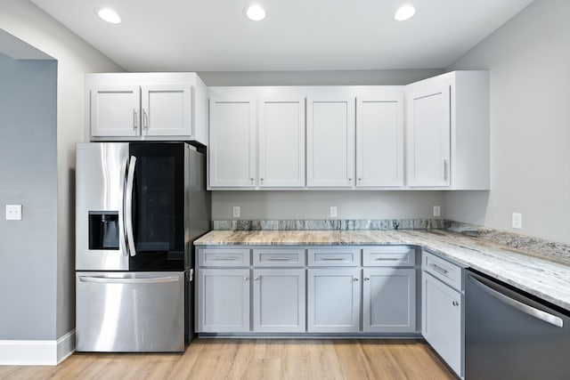 43 Mcilwee Ln, Staunton, VA 24401 - kitchen with stainless steel appliances, light stone countertops, light wood-style flooring, recessed lighting, and white cabinetry