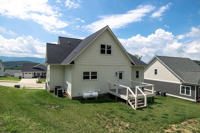 43 Mcilwee Ln, Staunton, VA 24401 - back of house with board and batten siding, a lawn, a deck with mountain view, and a shingled roof