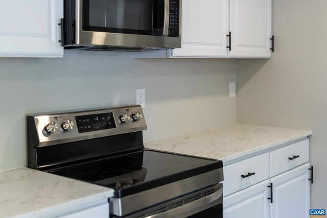 1805 Shenandoah Ave, Waynesboro, VA 22980 - kitchen with appliances with stainless steel finishes, white cabinets, and light stone countertops