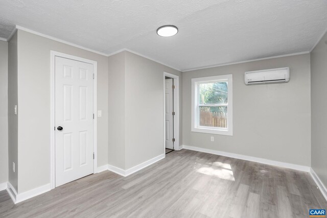 1805 Shenandoah Ave, Waynesboro, VA 22980 - unfurnished bedroom with a wall mounted AC, wood finished floors, a textured ceiling, and crown molding