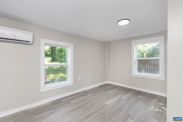 1805 Shenandoah Ave, Waynesboro, VA 22980 - spare room featuring an AC wall unit, plenty of natural light, and wood finished floors