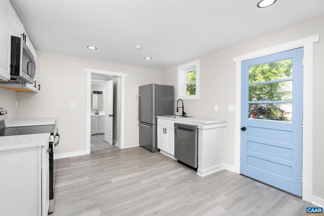 1805 Shenandoah Ave, Waynesboro, VA 22980 - kitchen featuring appliances with stainless steel finishes, light countertops, light wood-style flooring, recessed lighting, and white cabinets