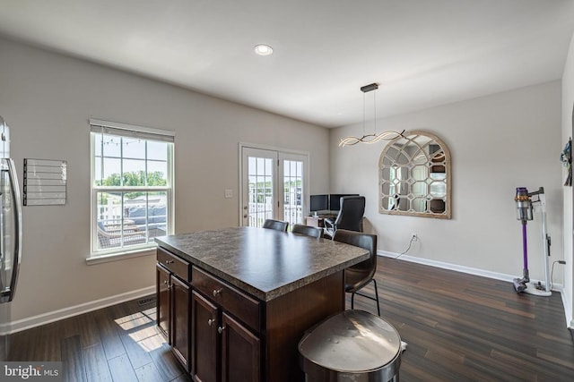 2015 Elm Tree Ct, Charlottesville, VA 22911 - kitchen with dark countertops, dark brown cabinets, dark wood-style flooring, french doors, and a kitchen bar