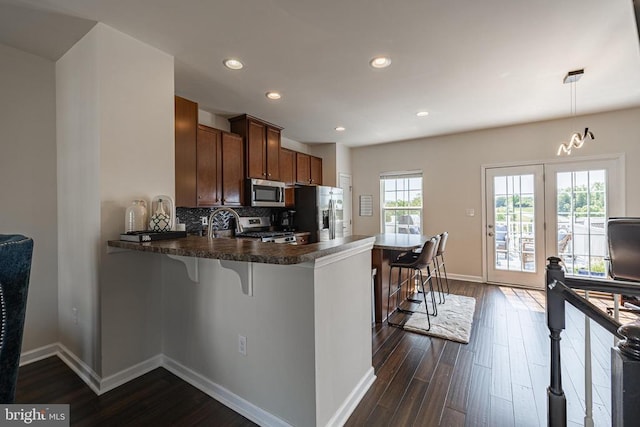 2015 Elm Tree Ct, Charlottesville, VA 22911 - kitchen with stainless steel appliances, a peninsula, dark wood-style floors, a breakfast bar, and recessed lighting