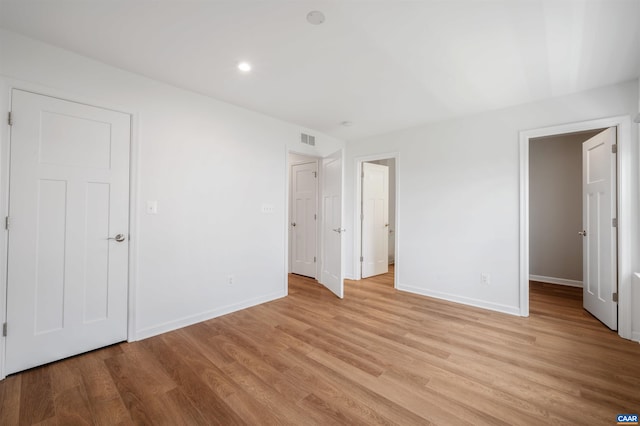 4454 Alston St, Crozet, VA 22932 - unfurnished bedroom featuring light wood-style flooring, recessed lighting, and a spacious closet