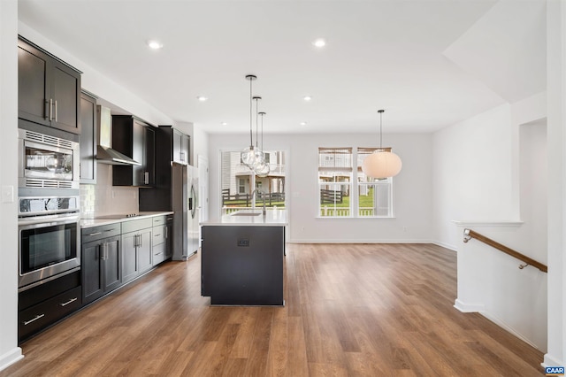 4454 Alston St, Crozet, VA 22932 - kitchen with appliances with stainless steel finishes, light countertops, an island with sink, wood finished floors, and pendant lighting