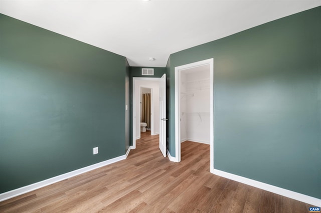 4454 Alston St, Crozet, VA 22932 - unfurnished bedroom featuring a closet, wood finished floors, and a walk in closet