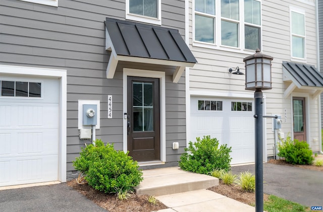 4454 Alston St, Crozet, VA 22932 - property entrance with a garage, a standing seam roof, a metal roof, and driveway