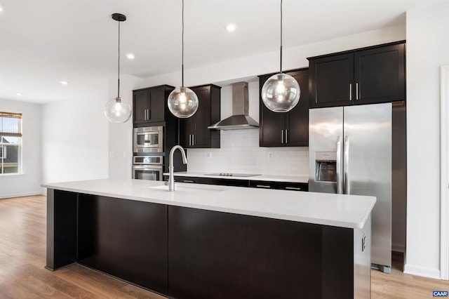 4454 Alston St, Crozet, VA 22932 - kitchen with wall chimney exhaust hood, appliances with stainless steel finishes, tasteful backsplash, light countertops, and light wood finished floors