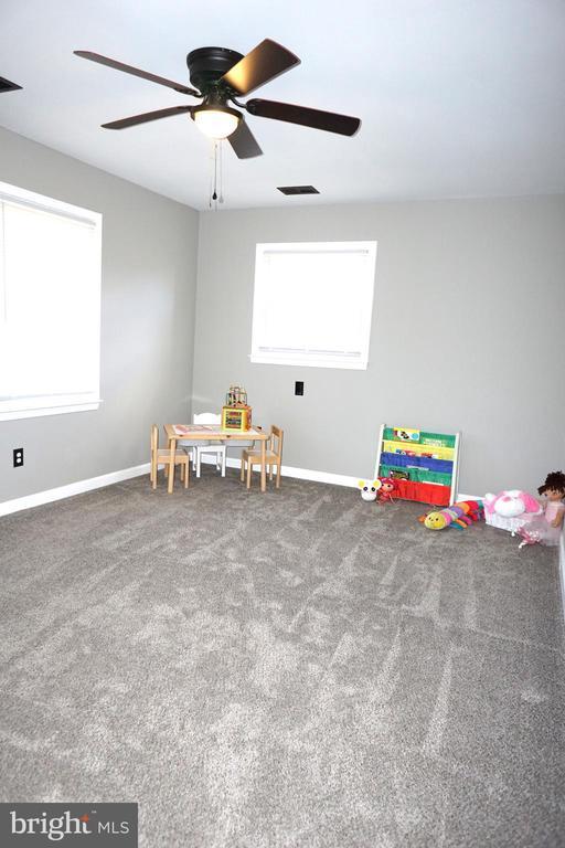 7435 Courthouse Rd, Spotsylvania, VA 22551 - playroom with baseboards, healthy amount of natural light, a ceiling fan, and carpet