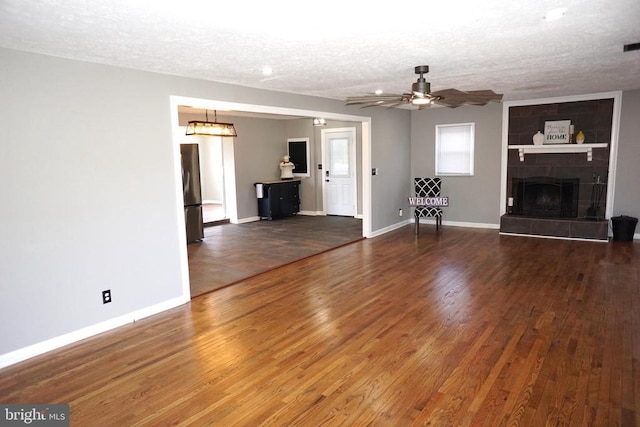 7435 Courthouse Rd, Spotsylvania, VA 22551 - unfurnished living room featuring a textured ceiling, wood finished floors, baseboards, and ceiling fan