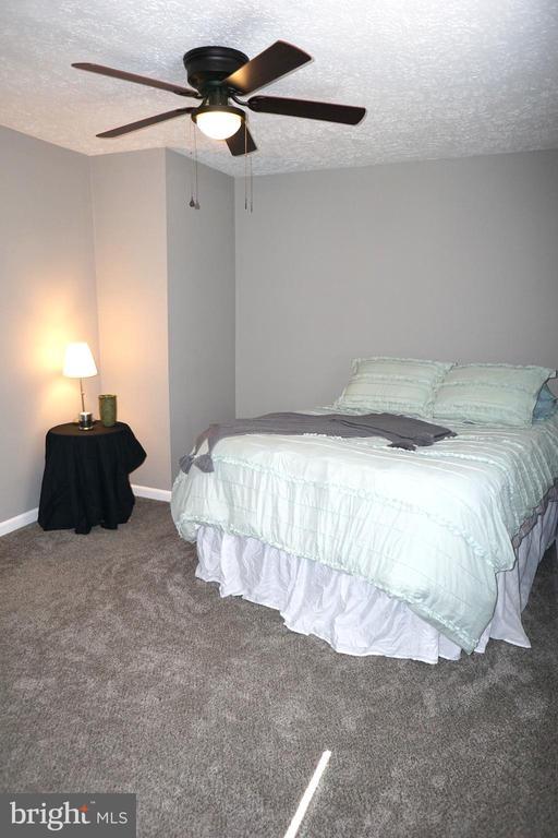 7435 Courthouse Rd, Spotsylvania, VA 22551 - bedroom with carpet, a textured ceiling, baseboards, and ceiling fan
