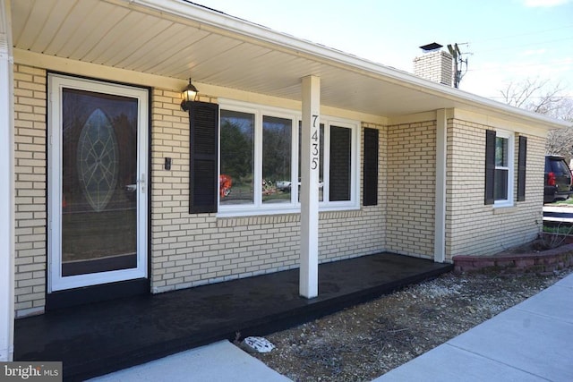 7435 Courthouse Rd, Spotsylvania, VA 22551 - doorway to property with brick siding, covered porch, and a chimney