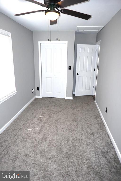 7435 Courthouse Rd, Spotsylvania, VA 22551 - unfurnished bedroom with a closet, carpet flooring, baseboards, and ceiling fan