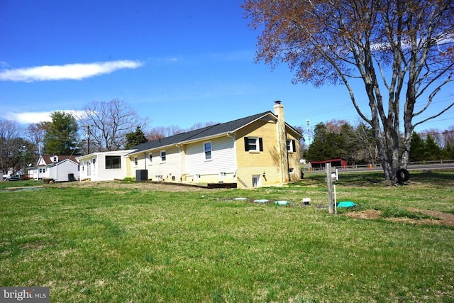 7435 Courthouse Rd, Spotsylvania, VA 22551 - rear view of house with a chimney, a lawn, central air condition unit, and brick siding