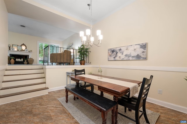 147 Scarborough Pl, Charlottesville, VA 22903 - dining area featuring a chandelier, stone finish flooring, baseboards, and lofted ceiling