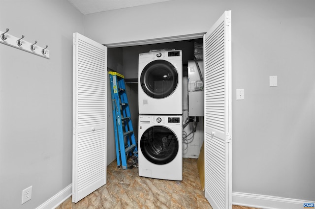 147 Scarborough Pl, Charlottesville, VA 22903 - laundry area featuring stacked washer and clothes dryer and baseboards