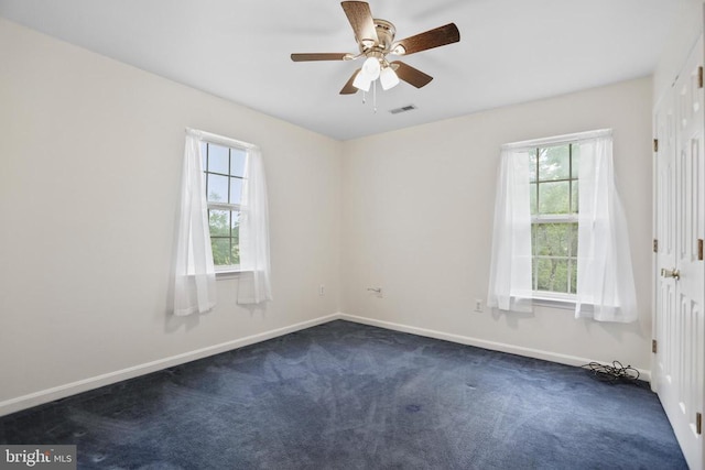 9071 Old Culpeper Rd, Warrenton, VA 20186 - empty room featuring plenty of natural light, dark carpet, and ceiling fan