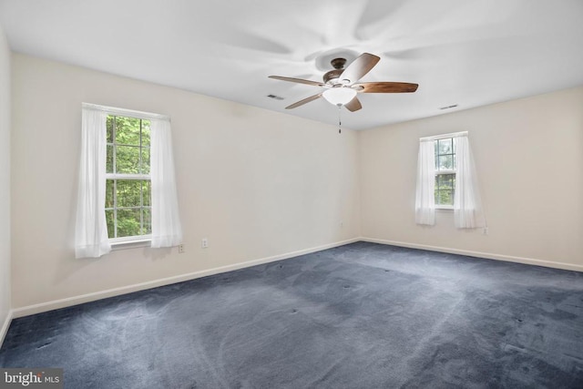 9071 Old Culpeper Rd, Warrenton, VA 20186 - empty room featuring plenty of natural light, dark carpet, and ceiling fan