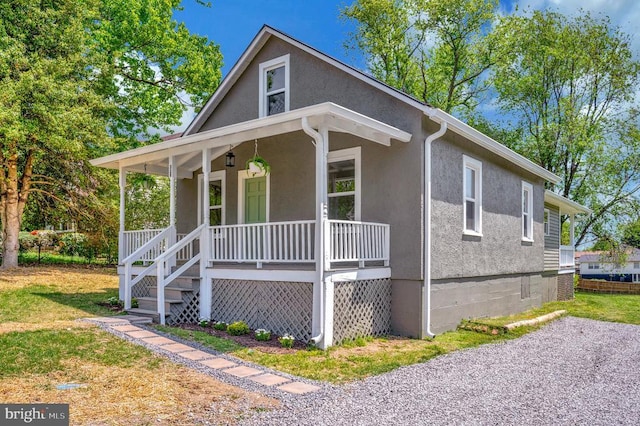 view of front of home featuring a porch and stucco siding
