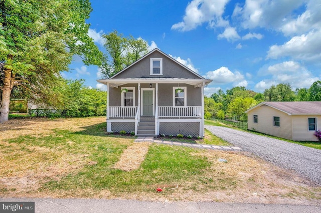 bungalow-style house with covered porch and a front yard