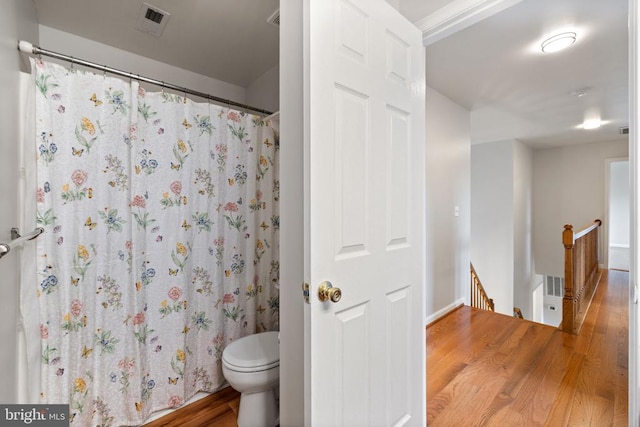  - full bath with wood finished floors, toilet, a shower with curtain, and baseboards