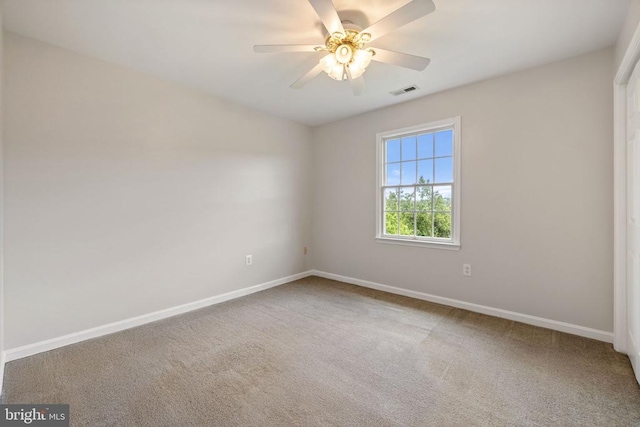  - carpeted empty room with baseboards and ceiling fan
