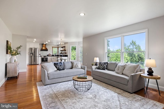  - living area featuring baseboards, wood finished floors, a chandelier, and recessed lighting