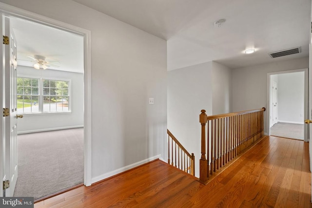  - hallway with an upstairs landing, wood-type flooring, and baseboards