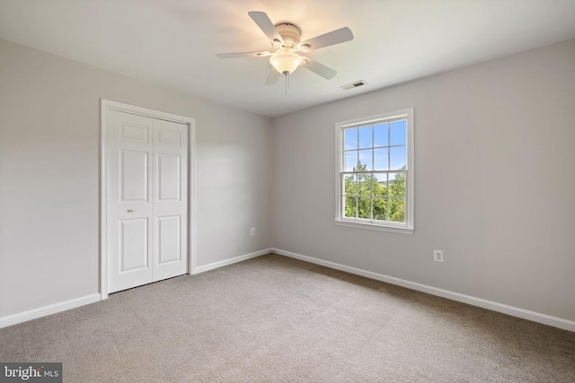 - unfurnished bedroom with carpet, baseboards, a closet, and ceiling fan