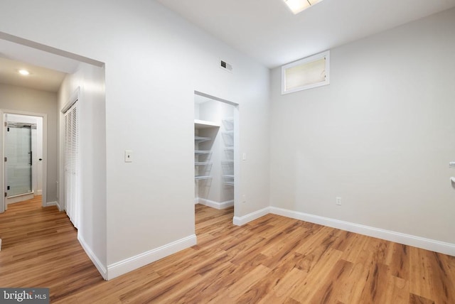  - spare room featuring light wood-type flooring, baseboards, and recessed lighting