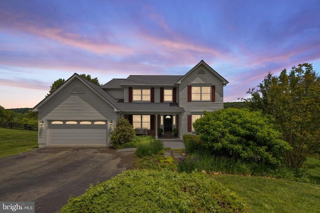 - traditional home with driveway, a porch, and a garage