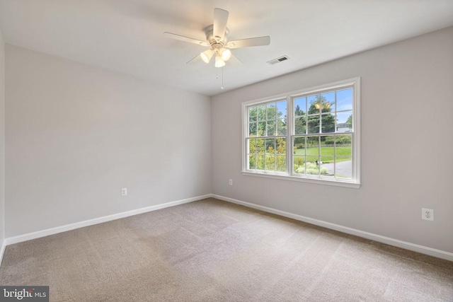  - carpeted empty room featuring baseboards and ceiling fan