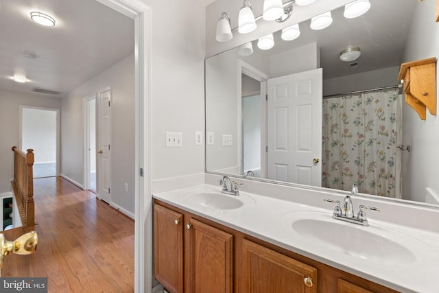  - full bath featuring double vanity and wood finished floors