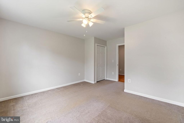  - carpeted spare room with ceiling fan and baseboards