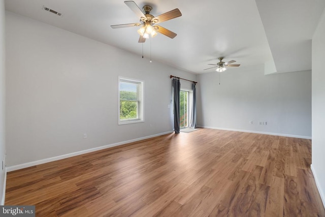  - empty room with a ceiling fan, light wood-style floors, and baseboards
