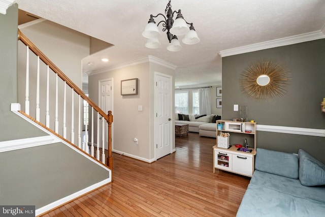 5008 Blake Dr, Fredericksburg, VA 22407 - living area featuring ornamental molding, stairs, light wood finished floors, a chandelier, and recessed lighting