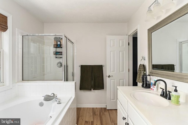 5008 Blake Dr, Fredericksburg, VA 22407 - full bathroom with vanity, a bath, a shower stall, and wood finished floors