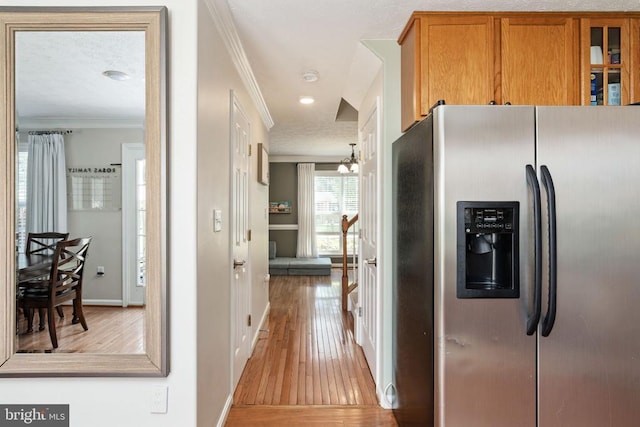 5008 Blake Dr, Fredericksburg, VA 22407 - kitchen featuring stainless steel refrigerator with ice dispenser, ornamental molding, light wood-style flooring, brown cabinets, and glass insert cabinets