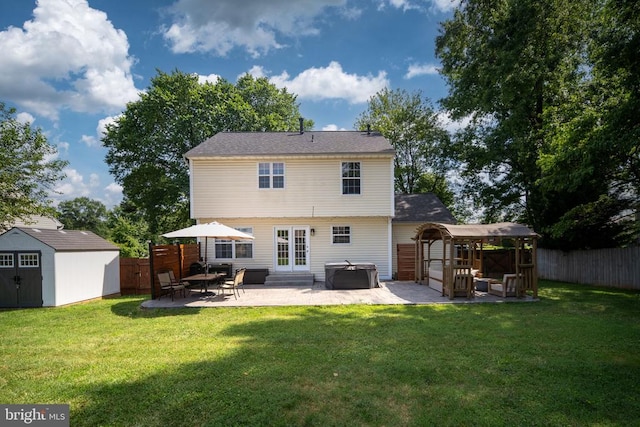 5008 Blake Dr, Fredericksburg, VA 22407 - back of house featuring a hot tub, a patio area, a storage unit, a gazebo, and a fenced backyard