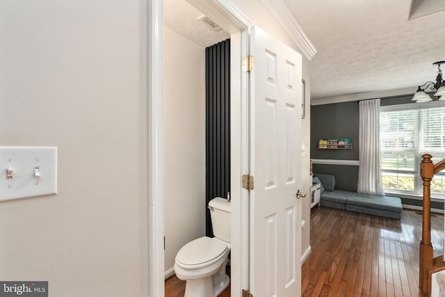 5008 Blake Dr, Fredericksburg, VA 22407 - bathroom with a textured ceiling, wood-type flooring, and ornamental molding